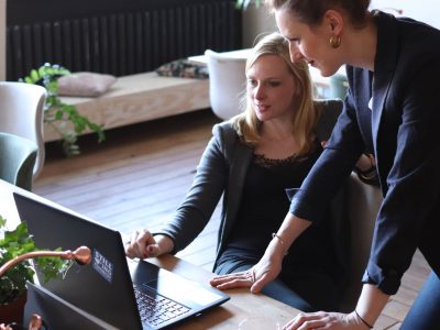 Image of two women looking at a laptop