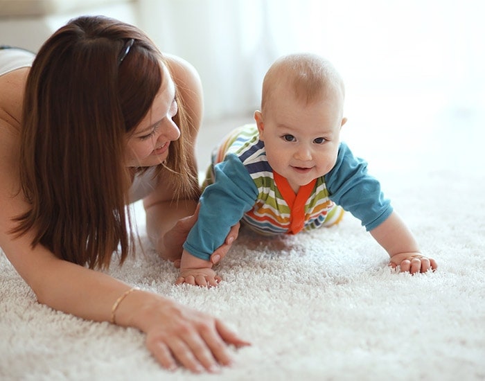 Baby nurse playing with an infant