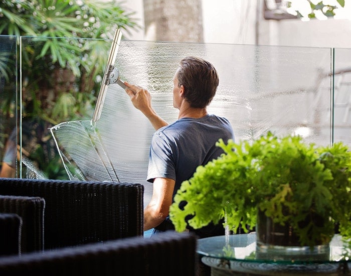 Houseman cleaning a window