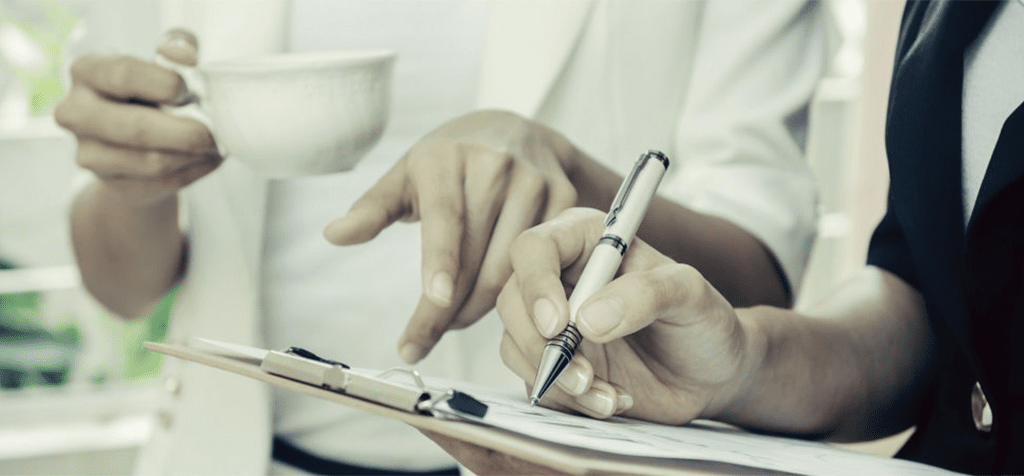 Woman Writing on Notepad