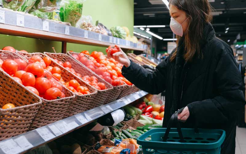 Woman Holding a Tomato