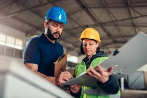 man and women with hard hats looking at chart