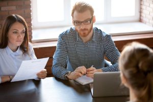 man and women interviewing female in an office