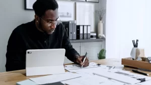 Payroll Administrator sitting a desk working on paperwork