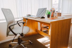 picture of a desk with a chair in front of it in an office
