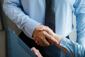 personal assistant giving a handshake to another person