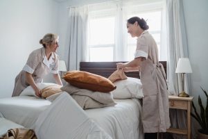 2 cleaner ladies making a bed