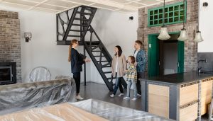 a house manager taking a family through a house