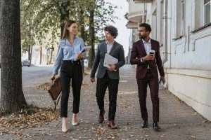 A bunch of people in suits walking down the street