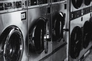A bunch of washing machines in a black and white photo