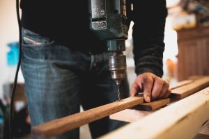 A handyman drilling into some wood