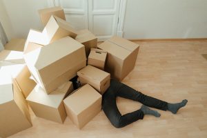 A person underneath a box