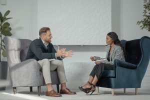 Two people sitting in chairs in an interview