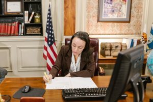 A legal assistant writing down on a document