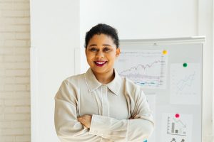 A lady standing in front of a white board