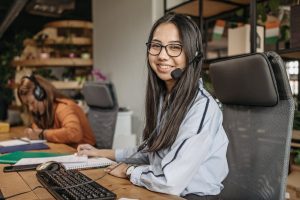 An office worker smiling at her desk