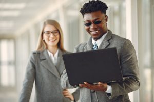 A couple people looking at a laptop