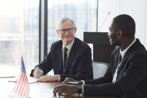 A couple people talking about work at an office table