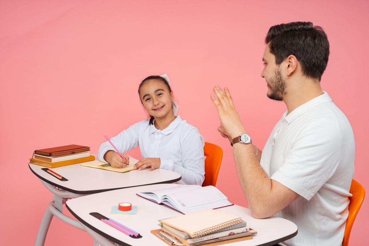 A man doing a tutoring lesson with a small child